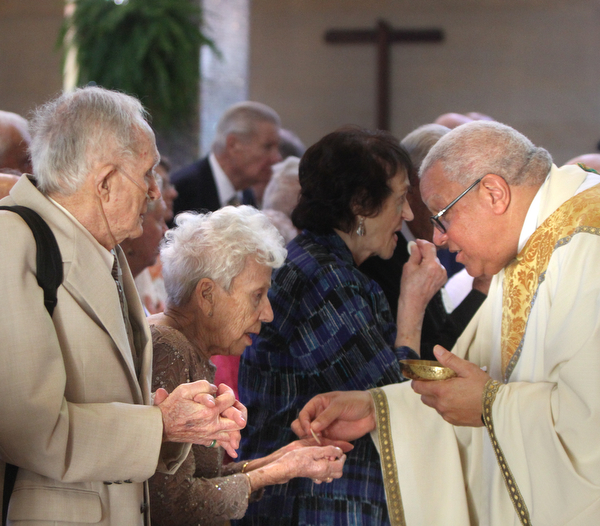 William D. Lewis\The Vindicator.John and Nancy Burke, of St Edward Parish Youngstown who have been married 66 years, receive communion from Bishop George Murry during Wedding Anniversary MassSunday June 5, 2016 at St. Columba Cathedral in Youngstown.