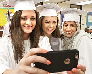 William D. Lewis\The Vindicator.Boardman graduates from a selfie before Sunday June 5, 2016 commencement ceremony at Boardman High School.From left they are: Brittany Christmas, Emily Fetsko and Noelle Abuoraq.
