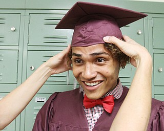 William D. Lewis\The Vindicator.Boardman graduate Hector Colon gets some help with his cap before the Sunday June 5, 2016 commence at Boardman High School.