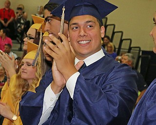 Lowellville graduate Cristian Montanez looks towards his family in the crowd and gives them a round of applause during the Lowellville High School commencement on Sunday afternoon.   Dustin Livesay  |  The Vindicator  6/5/16  Lowellville High School.