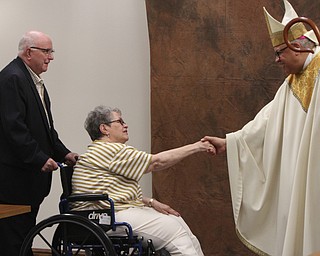 William D. Lewis\The Vindicator.Timothy and Kathleen Moriarty of St. Luke parish get greetings from Bishop George Murry after Wedding Anniversary Mass Sunday June 5, 2016 at St. Columba Cathedral in Youngstown.