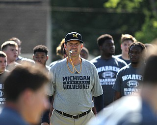 Nikos Frazier | The Vindicator..Jim Harbaugh, Michigan Football Head Coach, watches as players run during the Warren Harding Elite Camp.