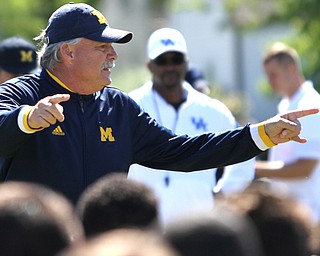 Nikos Frazier | The Vindicator..Don Brown, Michigan Defensive Coordinator, illustrates the next drill players in the Warren Harding Elite Camp will run.