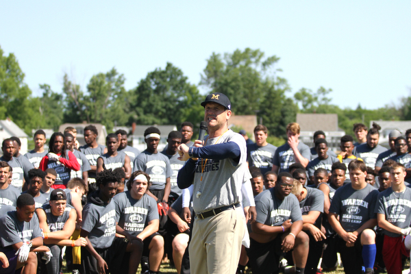 Nikos Frazier | The Vindicator..Jim Harbaugh, Michigan Football Head Coach, points to different stations players in the Warren Harding Elite Camp will rotate though on Thursday, June 9, 2016.