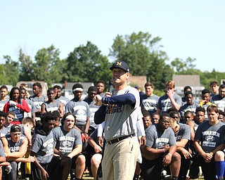 Nikos Frazier | The Vindicator..Jim Harbaugh, Michigan Football Head Coach, points to different stations players in the Warren Harding Elite Camp will rotate though on Thursday, June 9, 2016.