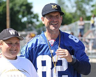 Nikos Frazier | The Vindicator..Jim Harbaugh, Michigan Football Head Coach, poses with Anthony Campbell-Hauggins, 11, of Warren.