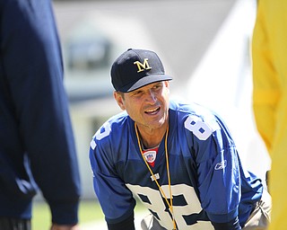 Nikos Frazier | The Vindicator..Jim Harbaugh, Michigan Football Head Coach, watches as players run during the Warren Harding Elite Camp.
