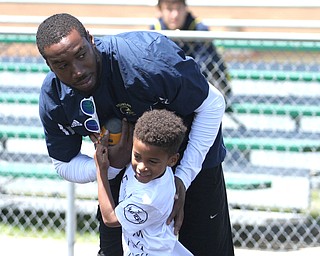 Nikos Frazier | The Vindicator..Mario Manningham(top) plays with his son, Mario Manningham Jr., 5, during the Warren Harding Elite Camp. Manningham, originally from Warren, played for Harbaugh and the 49ers in 2012 and 2013 as well as Michigan State in college.