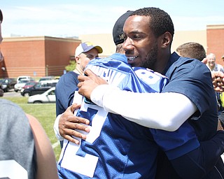 Nikos Frazier | The Vindicator..Jim Harbaugh(left), Michigan Head Coach, embraces Mario Manningham(right), after the Warren Harding Elite Camp. Manningham, originally from Warren, played for Harbaugh and the 49ers in 2012 and 2013 as well as Michigan State in college.