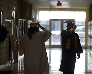 ROBERT K. YOSAY | THE VINDICATOR..seniors pause inthe hallway to adjust tasssels..Jackson Milton Class of 2016.... ... - -30-.