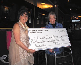 SPECIAL TO THE VINDICATOR
Nina Lowery, left, president of Boardman-Poland Junior Women’s League, presents a check to Sister Anne, representative of the Dorothy Day House.