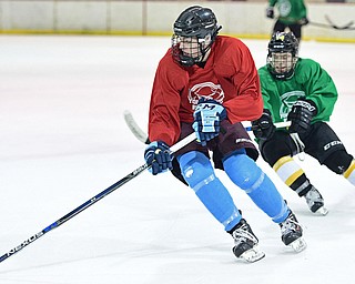 BOARD MAN, OHIO - JUNE 10, 2016: Nolan Barrett (red) skates with the puck trying to avoid Alexander Miniouchine (green) during a exhibition game during the Phantoms prospect camp Friday night at the Ice Zone. DAVID DERMER | THE VINDICATOR