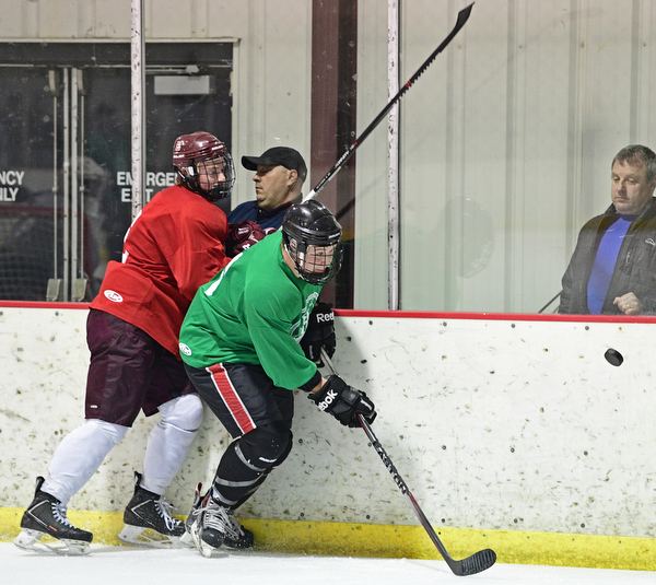 BOARD MAN, OHIO - JUNE 10, 2016: Marc Anthony (green) skates for the puck after being checked from behind by Wyatt Wutzke (red) during a exhibition game during the Phantoms prospect camp Friday night at the Ice Zone. DAVID DERMER | THE VINDICATOR
