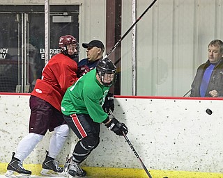 BOARD MAN, OHIO - JUNE 10, 2016: Marc Anthony (green) skates for the puck after being checked from behind by Wyatt Wutzke (red) during a exhibition game during the Phantoms prospect camp Friday night at the Ice Zone. DAVID DERMER | THE VINDICATOR