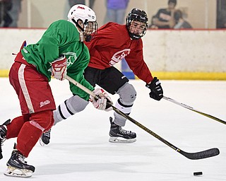 BOARD MAN, OHIO - JUNE 10, 2016: Nick Siffringer (green) skates with he puck while being chased by Maz Alsaraaf (red) during a exhibition game during the Phantoms prospect camp Friday night at the Ice Zone. DAVID DERMER | THE VINDICATOR