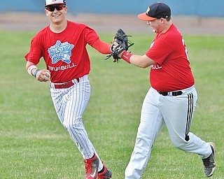 Jeff Lange | The Vindicator  FRI, JUN 10, 2016 - Trumbull County outfielders Garrett Pitts of Niles McKinley (left) and Aaron Frantz of Mineral Ridge celebrate after Pitts caught a fly ball to end the top of the second inning of Friday's Valley High School All Star Game at Eastwood Field in Niles.