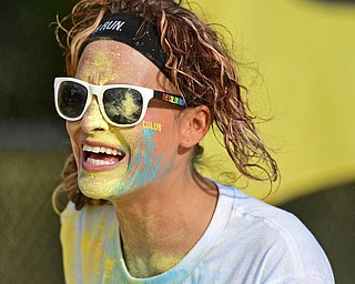 YOUNGSTOWN, OHIO - JUNE 11, 2016: Katie Fox of Newton Falls smiles after running through a cloud of yellow powder while running down West Front Street during the Color Run, Saturday morning. DAVID DERMER | THE VINDICATOR