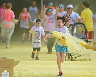 YOUNGSTOWN, OHIO - JUNE 11, 2016: Gabby Mitchell 9, of McDonald smiles while running through a cloud of yellow powder while running down West Front Street during the Color Run, Saturday morning. DAVID DERMER | THE VINDICATOR