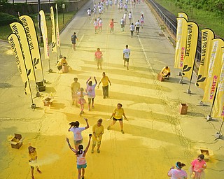 YOUNGSTOWN, OHIO - JUNE 11, 2016: Runner run through the yellow power station on West Front Street during the Color Run, Saturday morning. DAVID DERMER | THE VINDICATOR
