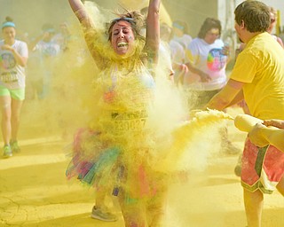 YOUNGSTOWN, OHIO - JUNE 11, 2016: Marisa Galvin of Howland smiles while being blasted with yellow powder on West Front Street during the Color Run, Saturday morning. DAVID DERMER | THE VINDICATOR