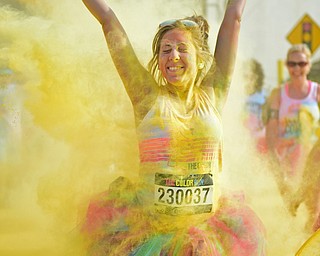 YOUNGSTOWN, OHIO - JUNE 11, 2016: Marisa Galvin of Howland smiles while being blasted with yellow powder on West Front Street during the Color Run, Saturday morning. DAVID DERMER | THE VINDICATOR