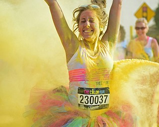 YOUNGSTOWN, OHIO - JUNE 11, 2016: Marisa Galvin of Howland smiles while being blasted with yellow powder on West Front Street during the Color Run, Saturday morning. DAVID DERMER | THE VINDICATOR