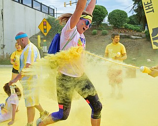 YOUNGSTOWN, OHIO - JUNE 11, 2016: Jen Gassman of Girard smiles while being blasted with yellow powder on West Front Street during the Color Run, Saturday morning. DAVID DERMER | THE VINDICATOR