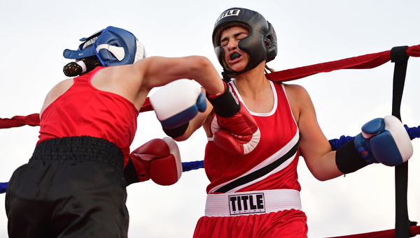 AUSTINTOWN, OHIO - JUNE 11, 2016: Erica Bayer of Struthers (right) is punched in the chest by Jordan Helgert of Pittsburgh (left) during the Fighting for Hope amateur boxing show, Saturday at the California Palms Hotel. DAVID DERMER | THE VINDICATOR