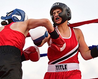 AUSTINTOWN, OHIO - JUNE 11, 2016: Erica Bayer of Struthers (right) is punched in the chest by Jordan Helgert of Pittsburgh (left) during the Fighting for Hope amateur boxing show, Saturday at the California Palms Hotel. DAVID DERMER | THE VINDICATOR