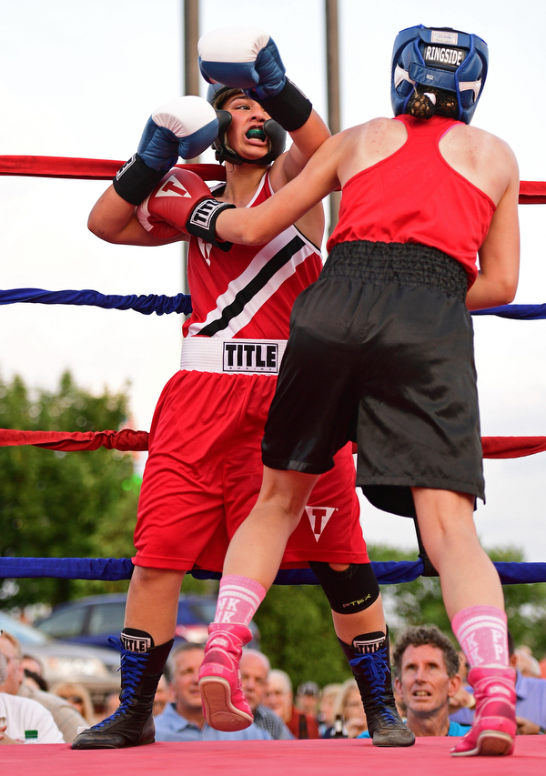 AUSTINTOWN, OHIO - JUNE 11, 2016: Erica Bayer of Struthers follows through with a punch while in the clinch with Jordan Helgert of Pittsburgh during the Fighting for Hope amateur boxing show, Saturday at the California Palms Hotel. DAVID DERMER | THE VINDICATOR