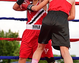 AUSTINTOWN, OHIO - JUNE 11, 2016: Erica Bayer of Struthers follows through with a punch while in the clinch with Jordan Helgert of Pittsburgh during the Fighting for Hope amateur boxing show, Saturday at the California Palms Hotel. DAVID DERMER | THE VINDICATOR