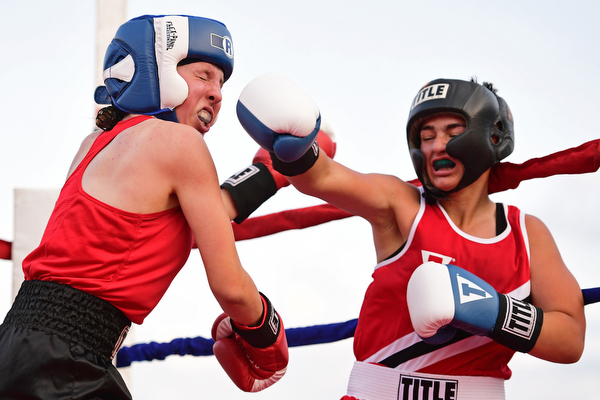 AUSTINTOWN, OHIO - JUNE 11, 2016: Erica Bayer of Struthers follows through with a punch to the head of Jordan Helgert of Pittsburgh during the Fighting for Hope amateur boxing show, Saturday at the California Palms Hotel. DAVID DERMER | THE VINDICATOR