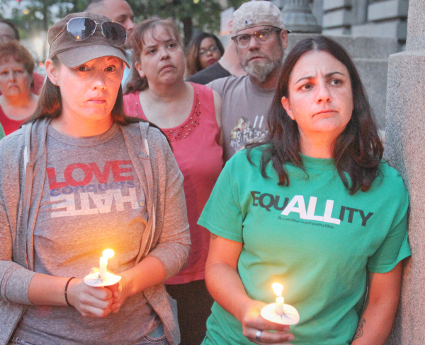 William D. Lewis the Vindicator  Married cdouple Desiree Lordi, left, and Chrissy Lordi of Youngstown during a candlelight vigil in Youngsotwn June 13, 2016 to remember Orlando shooting victims.