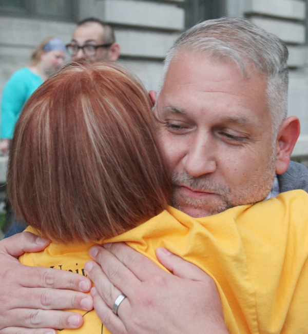 William D. Lewis the Vindicator  Jeanne tucker of Moneral ridge, back to camera, hugs Brian wells of Youngstown during a candlelight vigil in Youngsotwn June 13, 2016 to remember Orlando shooting victims.