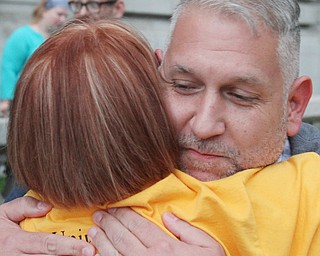 William D. Lewis the Vindicator  Jeanne tucker of Moneral ridge, back to camera, hugs Brian wells of Youngstown during a candlelight vigil in Youngsotwn June 13, 2016 to remember Orlando shooting victims.
