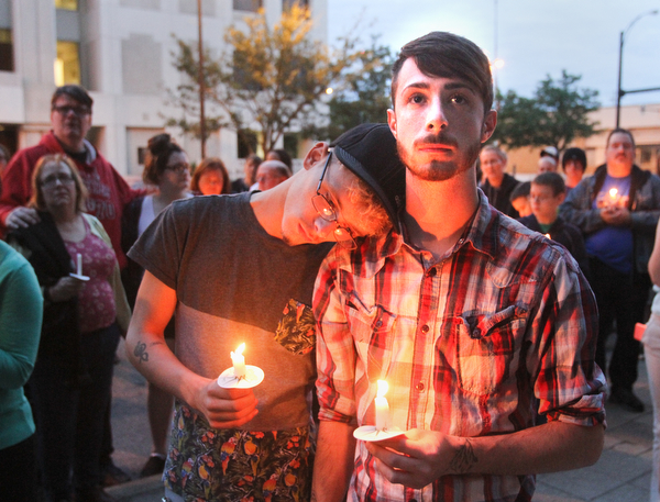 William D. Lewis the Vindicator  Nicholas King, left, and Larry Huston during a candlelight vigil in Youngstown June 13, 2016 to remember Orlando shooting victims.
