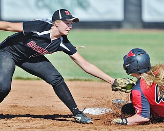 Jeff Lange | The Vindicator  TUE, JUN 14, 2016 - Mathews' Meredith Grimes (left) reaches out to tag Canfield's Amelia Manenti (43) in the second inning of game one of Tuesday's 13th annual Bill Sferra Softball Classic at YSU.