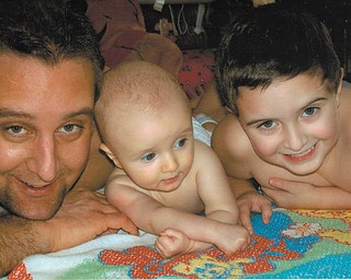 HERE IS OUR WINNING ENTRY: Heather Mileto sent this photo of her husband, Dominic, left, and their two boys, Antonio and Giovanni, taken on a hot summer day when the boys were just hanging around. It reminds her of when things weren't so crazy in their lives ... the simple days. They all live in Hubbard.