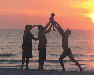 The three generations photo by Becky DiRusso is of her husband, Grandpa Dave; Dante, father of Dimarco; and Uncle Gavin, who were honoring the first grandson, son and nephew at sunset on Easter evening.