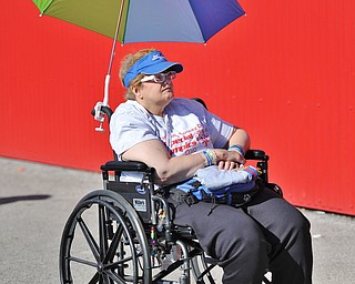 Jeff Lange | The Vindicator  SAT, JUN 18, 2016 - Vicki Goist of the Mahoning County Board of Developmental Disability shields herself from the hot sun prior to the start of Saturday's Special Olympics event held at Austintown Fitch High School.