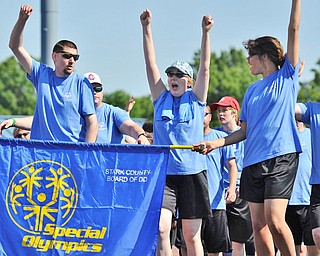 Jeff Lange | The Vindicator  SAT, JUN 18, 2016 - Members of the Stark Board of Developmental Disability team (from left) Paul Gines, Tara Dudley and Raquel Casline raise their arms in celebration of the start of Saturday's Special Olympics event at Austintown Fitch High School.