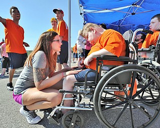 Jeff Lange | The Vindicator  SAT, JUN 18, 2016 - McKynzie Peed, an aid at Columbiana Opportunity Homes, motivates Stephaney Mix (seated) before her events in the Special Olympics held at Austintown Fitch High School on Saturday.