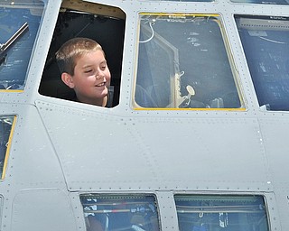 Jeff Lange | The Vindicator  SAT, JUN 18, 2016 - Nine year old Dillon Sumey of Edinburg, Pa. peeks out of the window of a C-130 Hercules during an open house at the Youngstown Air Reserve Station in Vienna on Saturday.