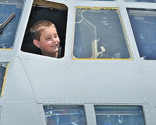 Jeff Lange | The Vindicator SAT, JUN 18, 2016 - Nine year old Dillon Sumey of Edinburg, Pa. peeks out of the window of a C-130 Hercules during an open house at the Youngstown Air Reserve Station in Vienna on Saturday.