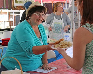 Terri Tepsic of the Serbian Orthodox Church serves a Cevapcici Dinner during the Simply Slovak festival in downtown Youngstown on Saturday afternoon.  Dustin Livesay  |  The Vindicator  6/18/16  Youngstown