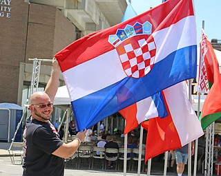 Chris Geddes of Warren holds out the flag of Croatia to show his heritage during the Simply Slovak festival in downtown Youngstown on Saturday afternoon.  Dustin Livesay  |  The Vindicator  6/18/16  Youngstown