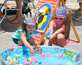 L-R) Alaina (2) and Ava (6) Liptak of Cortland pull rubber ducks out of a pool which is one of the many games available  during the Simply Slovak festival in downtown Youngstown on Saturday afternoon.  Dustin Livesay  |  The Vindicator  6/18/16  Youngstown
