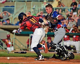 NILES, OHIO - JUNE 18, 2016: Batter Juan Gomes #11 of the Scrappers leave the batters box after striking out while catcher Arden Pabst #52 of the Black Bears chases the ball to throw to first for the out in the third inning of Saturday nights game at Eastwood Field. DAVID DERMER | THE VINDICATOR