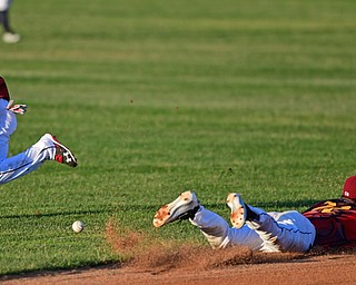 NILES, OHIO - JUNE 18, 2016: Short stop Luke Wakamatsu #22 (right) slides in the dirt while second basemen Alexis Pantoja #22 of the Scrappers chase after the ball in the fifth inning of Saturday nights game at Eastwood Field. DAVID DERMER | THE VINDICATOR