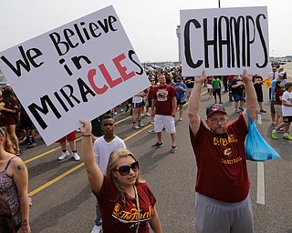 Cleveland Cavaliers fans hold up signs before the arrival of the team in Cleveland, Monday, June 20, 2016. Lebron James came home with the trophy he promised, and the championship Cleveland has coveted for 52 years. The NBA superstar, born and raised in nearby Akron, stepped off a plane Monday and hoisted the shiny Larry O'Brien Trophy as more than 10,000 fans celebrated the city's first title since 1964. (AP Photo/Tony Dejak)